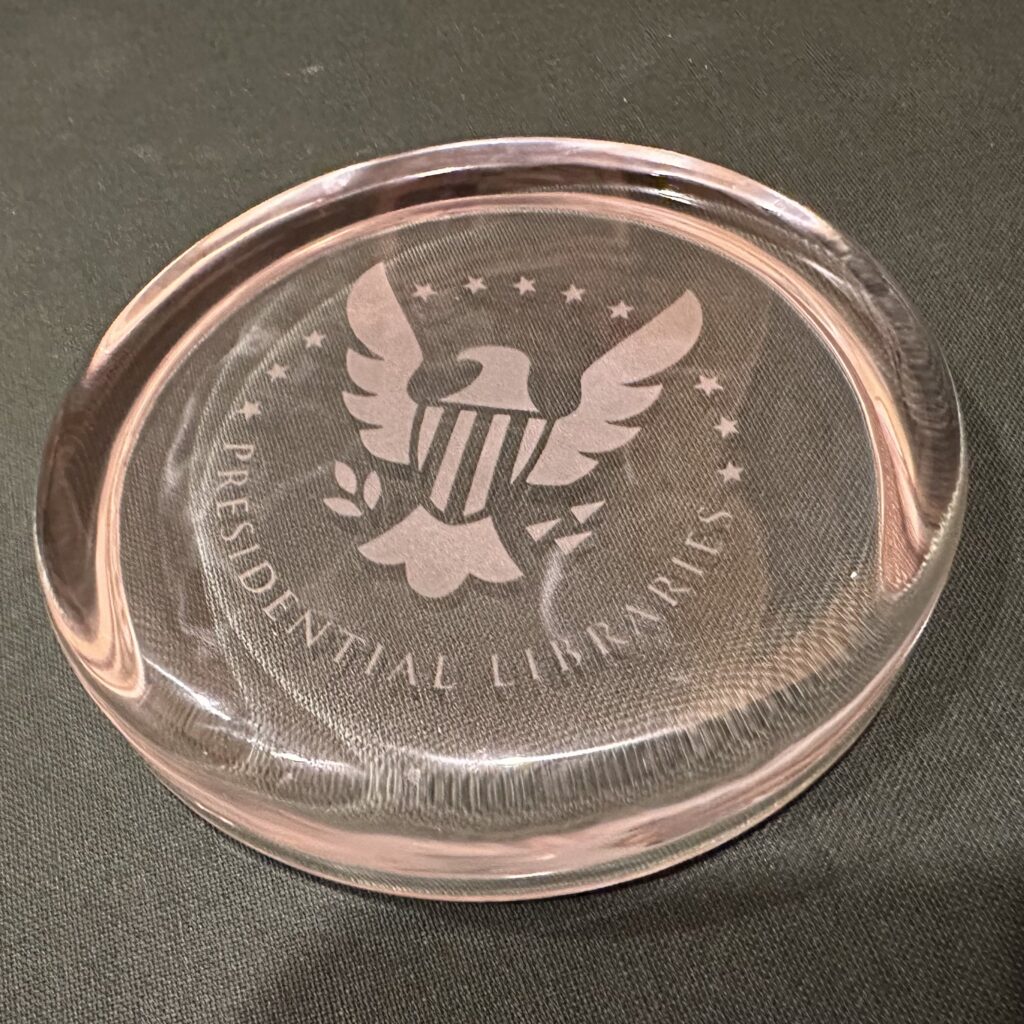 A macro picture of the crystal paperweight given to those who complete the National Archives' Presidential Library Passport by getting all pages stamped.